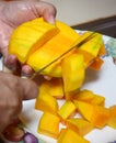 Peel the mango on a plate in the kitchen Royalty Free Stock Photo