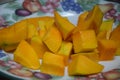 Peel the mango on a plate in the kitchen Royalty Free Stock Photo