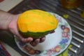 Peel the mango on a plate in the kitchen Royalty Free Stock Photo