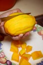 Peel the mango on a plate in the kitchen Royalty Free Stock Photo