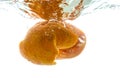 The peel from a whole mandarin thrown into the water. View from under the water Royalty Free Stock Photo
