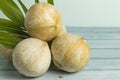 Peel young coconut with green leaves. Royalty Free Stock Photo