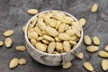 Peeled almond kernel on dark background. A bowl of almonds