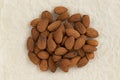 Peeled almond nuts isolated on parchment paper