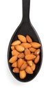 Peeled almonds in black spoon isolated on white background. Royalty Free Stock Photo