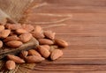 Peeled almonds. A pile of raw almonds on a wooden table. Nuts photo. Country style Royalty Free Stock Photo