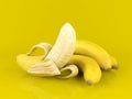 Peeled banana and bunch of bananas on yellow background Royalty Free Stock Photo