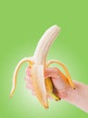 Peeled banana in hand Royalty Free Stock Photo