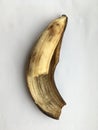 A peeled bitten ripe banana. Abstraction on a white background.