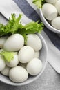 Peeled boiled quail eggs on grey table, flat lay