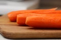 Peeled carrots on wooden chopping board. Royalty Free Stock Photo