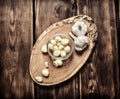 Peeled cloves of garlic on a wooden trunk. Royalty Free Stock Photo