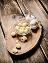 Peeled cloves of garlic on a wooden trunk. Royalty Free Stock Photo