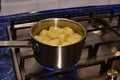 Peeled and diced potatoes in a saucepan.