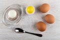 Peeled egg on egg stand, spoon, salt shaker, boiled eggs on wooden table. Top view Royalty Free Stock Photo