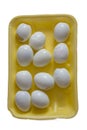 Peeled eggs lie in a yellow packing box, a meager Breakfast on a white background, isolated