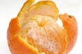 Peeled fruit with orange peel isolated on white
