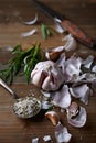 Peeled Garlic Bulb, Rosemary and Salt on a Kitchen Table Royalty Free Stock Photo