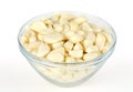 Peeled garlic cloves in glass bowl, front view Royalty Free Stock Photo