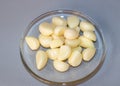Peeled garlic cloves on a plate. Preparation for pickling vegetables