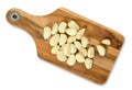 Peeled garlic cloves on wooden cutting board