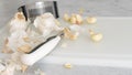 Peeled garlic, garlic press, and kitchen knife close-up on a white plastic cutting board Royalty Free Stock Photo