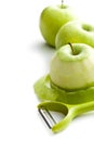 Peeled green apple with peeler