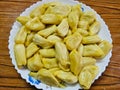 Peeled Jackfruits are kept on the white plate. It is delicious and juicy fruit.