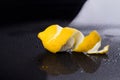 Peeled lemon on wet surface.