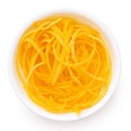 Peeled lemon zest in a white bowl from above
