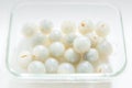 Peeled longan in a glass bowl isolated