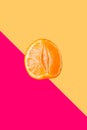 Peeled mandarin or clementine isolated on soft peach color background