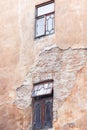 Peeled old brick wall with windows. Two windows in old building Royalty Free Stock Photo