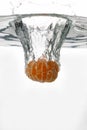 Peeled orange falls into the water Royalty Free Stock Photo