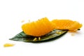 Peeled orange fruit pulp on green leaf isolated on white background. Macro photo of citrus fruit slice. Royalty Free Stock Photo