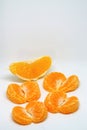 Peeled orange and mandarin slices on white isolated background Royalty Free Stock Photo