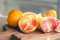 Peeled oranges on a wooden board on the kitchen table.