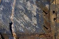 Peeled paint over wood boards from a boat hull, blue peeling paint wooden desk background, old wood texture traces of dark blue Royalty Free Stock Photo