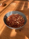Peeled Peanuts in Bowl with Wooden Surface Royalty Free Stock Photo