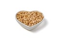 peeled pine nuts in a heart-shaped ceramic bowl isolated on white background Royalty Free Stock Photo