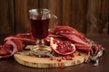 Peeled pomegranate, glass of pomegranate juice and jewerly on wooden board