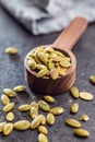 Peeled pumpkin seeds in wooden spoon on kitchen table