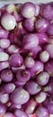 Peeled red onion in a container, used for cooking ingredients to make it more delicious.
