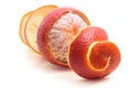Peeled red sicilian orange fruit and spiral shaped peel on white background Royalty Free Stock Photo