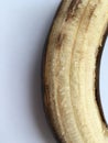 Peeled ripe banana lying close up on a white background. Minimalism. Royalty Free Stock Photo