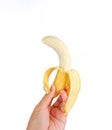 Peeled, ripe cavendish banana in human hand Royalty Free Stock Photo