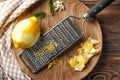 Peeled ripe lemon with zest and grater on wooden board Royalty Free Stock Photo