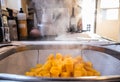 Peeled and square-shaped cuts of hot mango in a  metal strainer in the kitchen Royalty Free Stock Photo