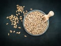 Peeled sunflower seeds in a glass bowl with a small wooden spoon on the black background. Close-up Royalty Free Stock Photo