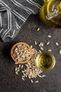 Peeled sunflower seeds in wooden bowl and oil Royalty Free Stock Photo